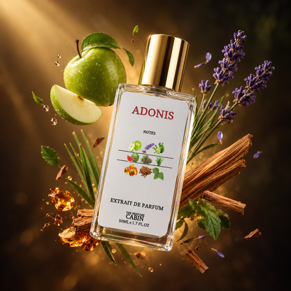 A clear rectangular perfume bottle labeled ADONIS Notes Extrait de Parfum by Cabin, with a gold cap, surrounded by a green apple, lavender sprigs, cinnamon sticks, and amber droplets on a dark warm background.