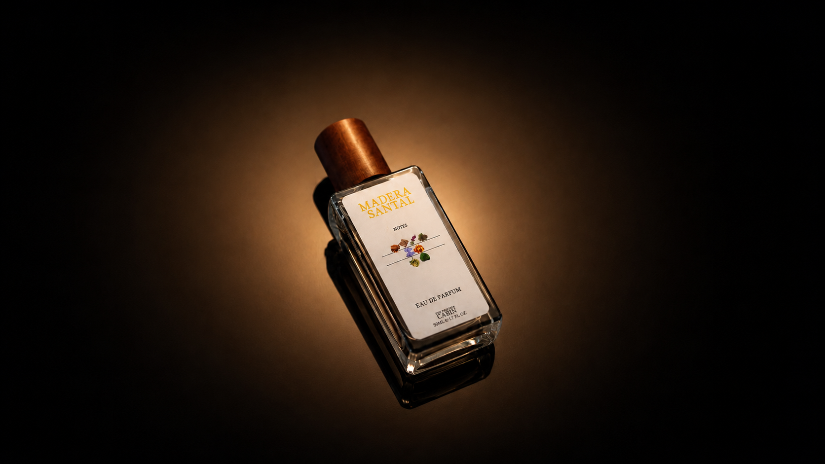 A rectangular glass perfume bottle with a metallic copper cap and a white label, photographed on a dark background with dramatic warm lighting.